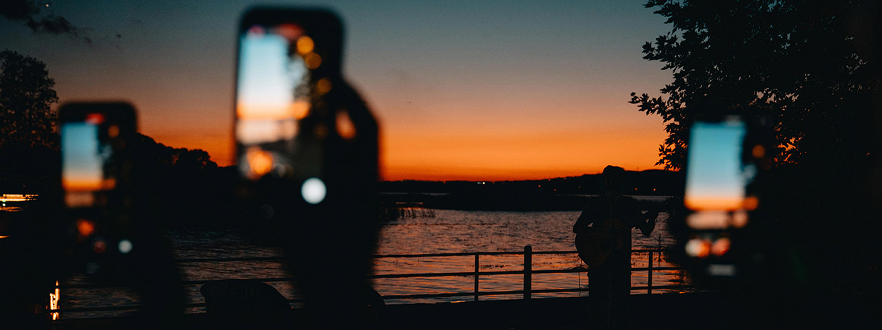 People Taking Pictures of the Sunset with Their Smartphones